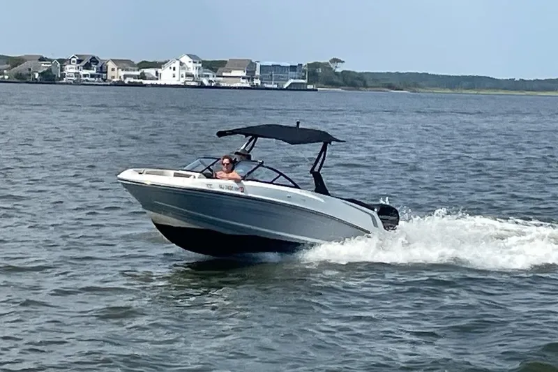 The Image of 2018 Bayliner VR5 Bowrider OB cruising on a scenic waterway. - 0