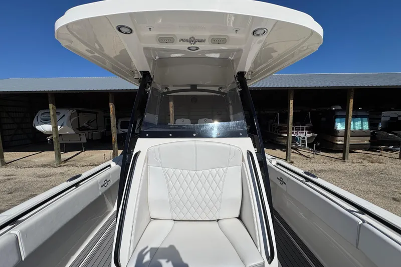 Slide: The Image of 2019 Fountain 34 Center Console boat with white seating and T-top in storage area. - 10