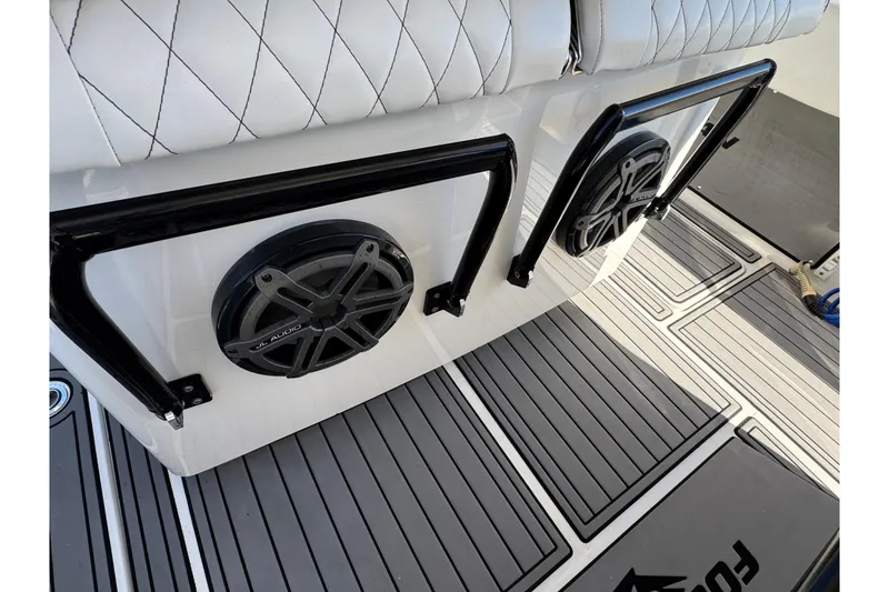Slide: The Image of 2019 Fountain 34 Center Console boat interior with JL Audio speakers and cushioned seating. - 14