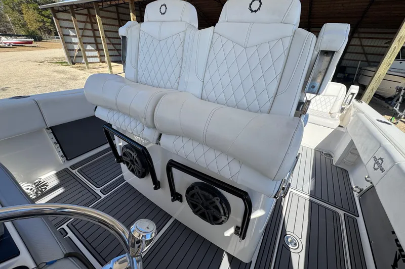 Slide: The Image of 2019 Fountain 34 Center Console boat with white quilted seats and marine speakers. - 17