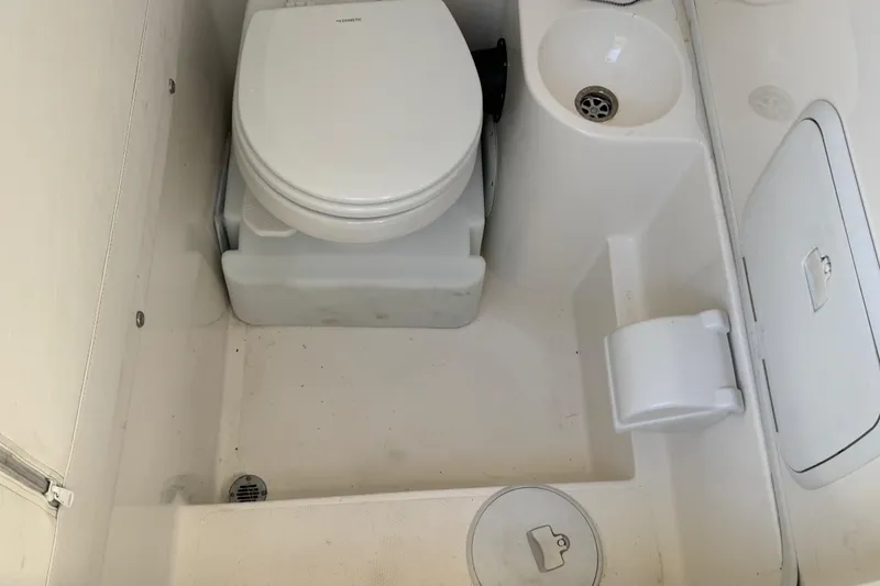 Slide: The Image of 2019 Fountain 34 Center Console boat bathroom with toilet and sink. - 18