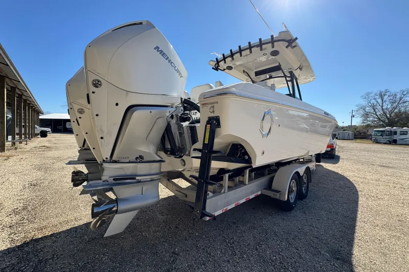Slide: The Image of 2019 Fountain 34 Center Console boat with dual Mercury engines on a trailer. - 4