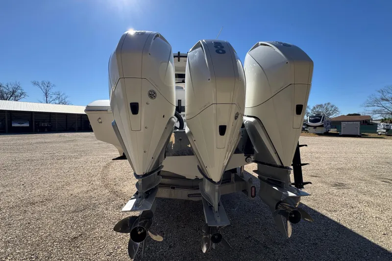 Slide: The Image of 2019 Fountain 34 Center Console with triple outboard engines in a sunny outdoor setting. - 5