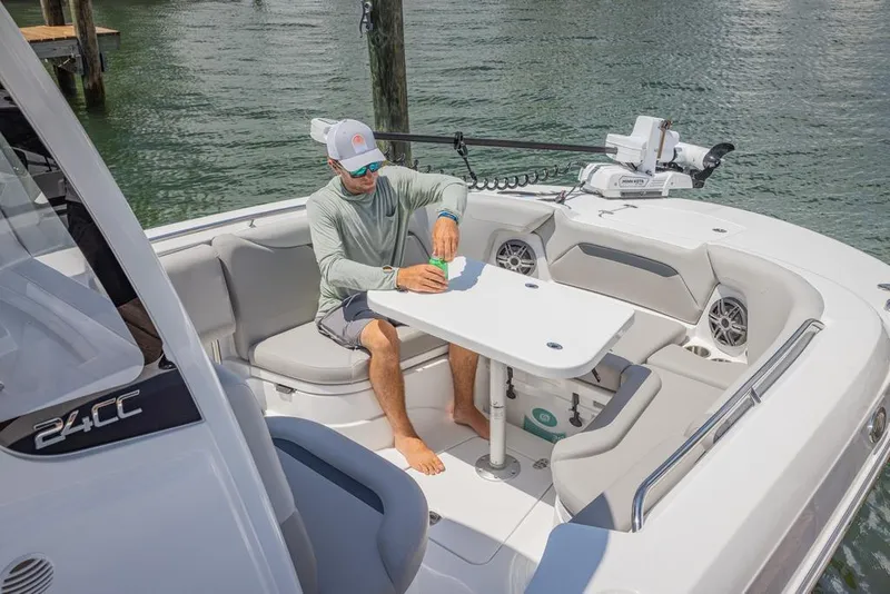 Slide: The Image of Man relaxing on 2026 Hurricane Center Console 24 OB boat, enjoying a drink. - 11