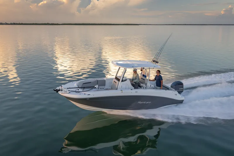 Slide: The Image of 2026 Hurricane Center Console 24 OB cruising on calm waters at sunset. - 19