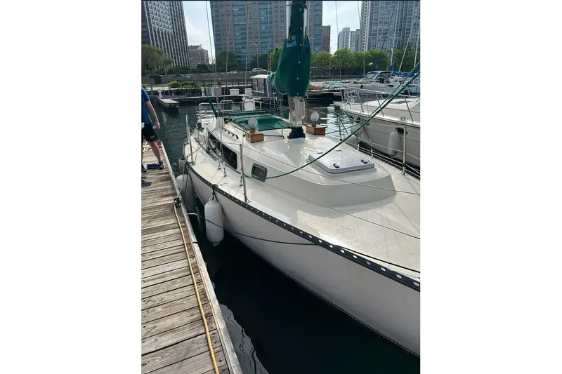 Slide: The Image of 1978 Kettenburg 32 sailboat docked in urban marina setting. - 1