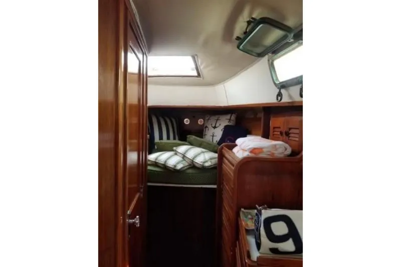Slide: The Image of Cozy cabin interior of 1978 Kettenburg 32 sailboat with nautical decor. - 11