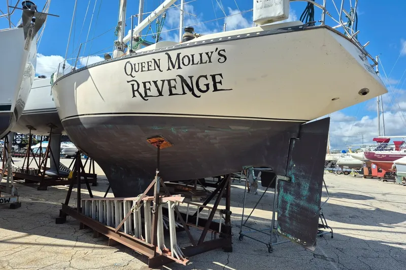Slide: The Image of 1978 Kettenburg 32 sailboat "Queen Molly's Revenge" on dry dock under clear skies. - 5