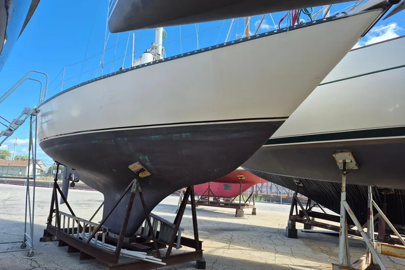 Slide: The Image of 1978 Kettenburg 32 sailboat on dry dock, showcasing hull and keel design. - 7