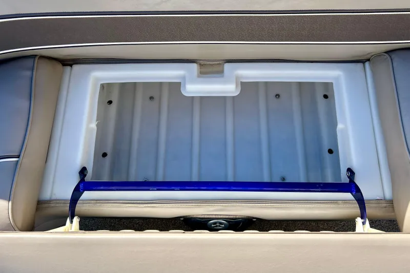 Slide: The Image of Storage compartment of a 2007 Premier 250 Intrigue boat, featuring a blue handle. - 16