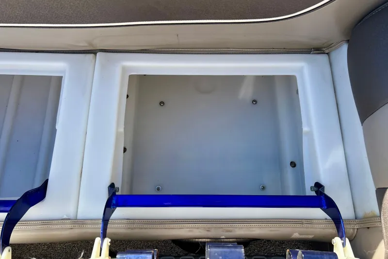 Slide: The Image of Storage compartment of a 2007 Premier 250 Intrigue boat, featuring a clean, white interior. - 17
