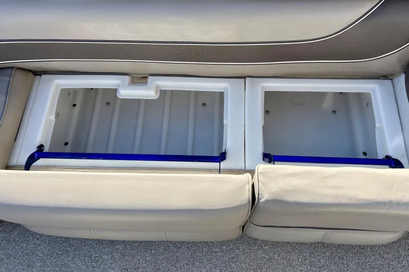 Slide: The Image of 2007 Premier 250 Intrigue boat storage compartments with beige seating. - 18