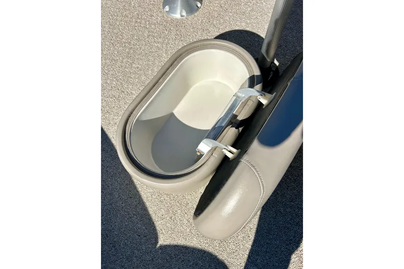 Slide: The Image of 2007 Premier 250 Intrigue boat seat storage compartment, open on a textured floor. - 23