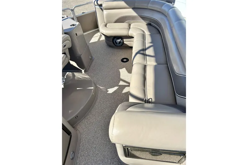 Slide: The Image of Interior of a 2007 Premier 250 Intrigue pontoon boat with beige seating. - 25