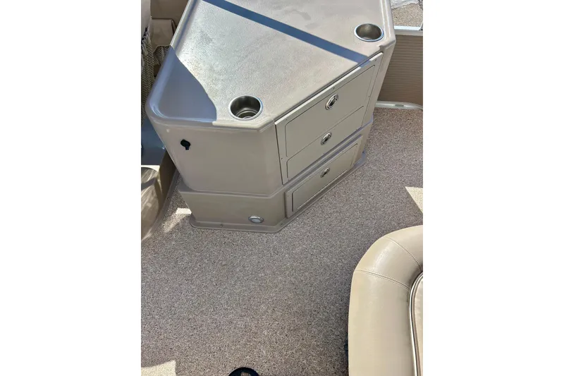 Slide: The Image of 2007 Premier 250 Intrigue boat interior with storage compartments and cup holders. - 27