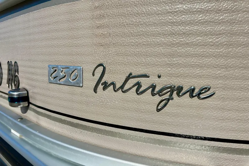 Slide: The Image of 2007 Premier 250 Intrigue boat emblem on textured surface. - 4