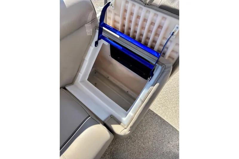 Slide: The Image of Open storage compartment in 2007 Premier 250 Intrigue boat seat, featuring blue accents. - 51