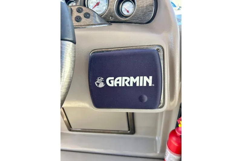 Slide: The Image of Dashboard of 2007 Premier 250 Intrigue with Garmin device and fire extinguisher. - 52