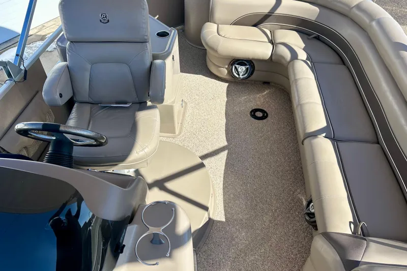 Slide: The Image of 2007 Premier 250 Intrigue boat interior with beige seating and steering wheel. - 56