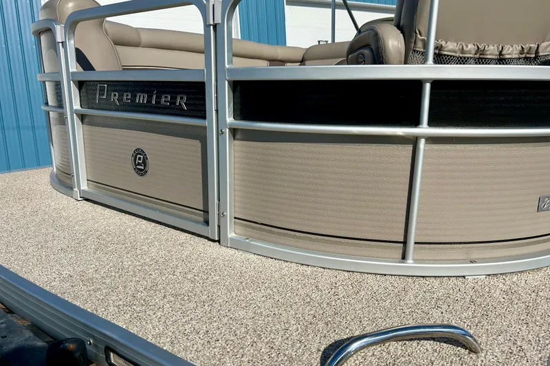 Slide: The Image of 2007 Premier 250 Intrigue pontoon boat with beige seating and metallic railing. - 57