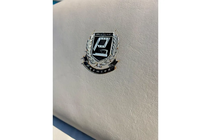 Slide: The Image of Emblem on 2007 Premier 250 Intrigue boat seat, featuring a laurel wreath design. - 58