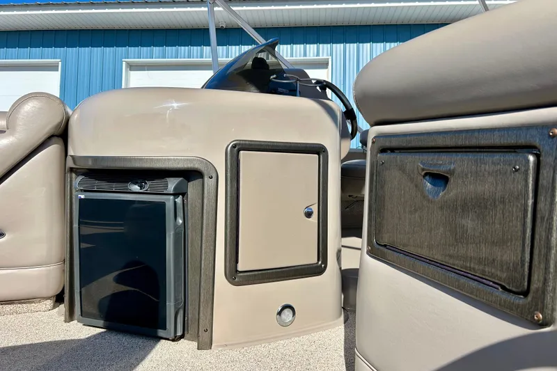 Slide: The Image of 2007 Premier 250 Intrigue boat interior with storage compartments and mini fridge. - 59