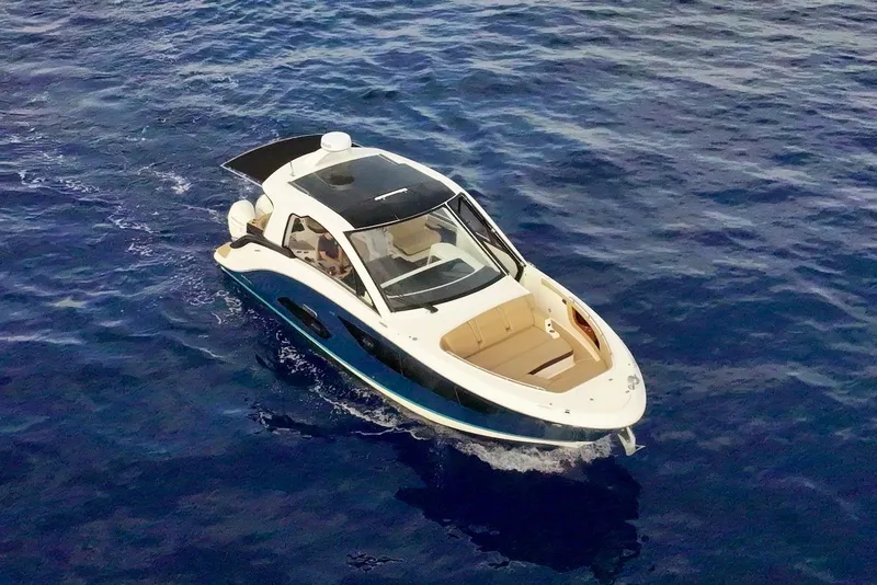 Slide: The Image of 2022 Sea Ray Sundancer 370 Outboard cruising on open blue water. - 10