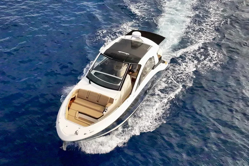 Slide: The Image of 2022 Sea Ray Sundancer 370 Outboard cruising on open blue water. - 11