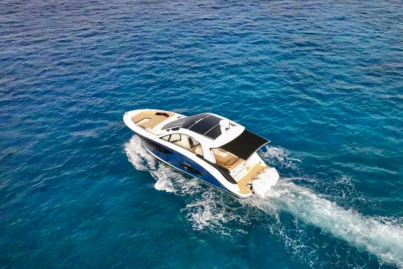 Slide: The Image of 2022 Sea Ray Sundancer 370 Outboard cruising on clear blue ocean waters. - 12