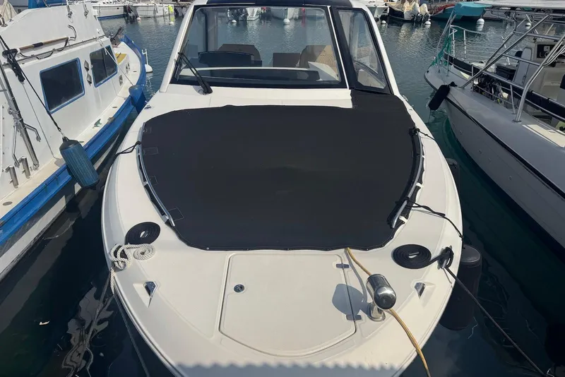 Slide: The Image of 2022 Sea Ray Sundancer 370 Outboard docked at marina, covered bow, surrounded by boats. - 13