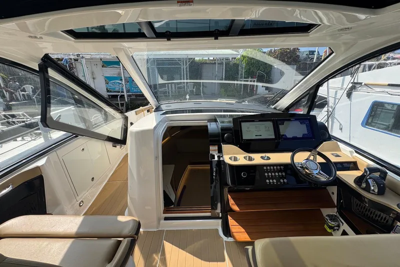 Slide: The Image of 2022 Sea Ray Sundancer 370 Outboard interior with modern helm and luxurious seating. - 16