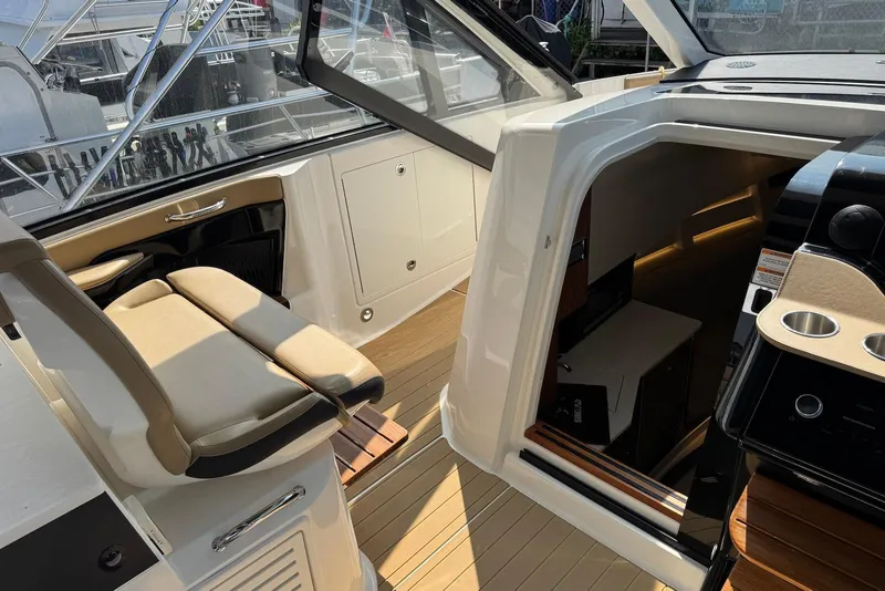 Slide: The Image of 2022 Sea Ray Sundancer 370 Outboard interior with seating and cabin entrance. - 17
