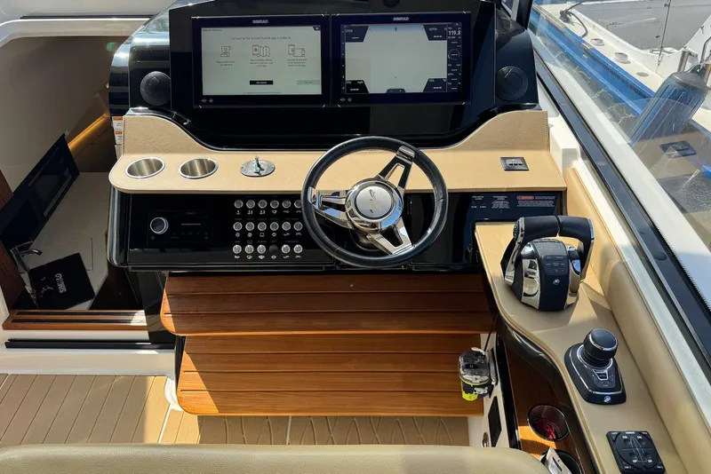 Slide: The Image of 2022 Sea Ray Sundancer 370 Outboard helm with modern controls and navigation displays. - 19