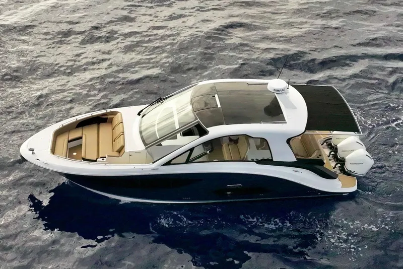 Slide: The Image of 2022 Sea Ray Sundancer 370 Outboard cruising on open water, aerial view. - 8