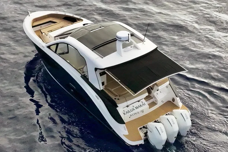 Slide: The Image of 2022 Sea Ray Sundancer 370 Outboard cruising on open water, rear view. - 9