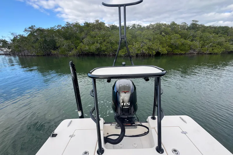 Slide: The Image of 2018 Hewes Redfisher 18 boat with Yamaha 115 engine on calm water near mangroves. - 11