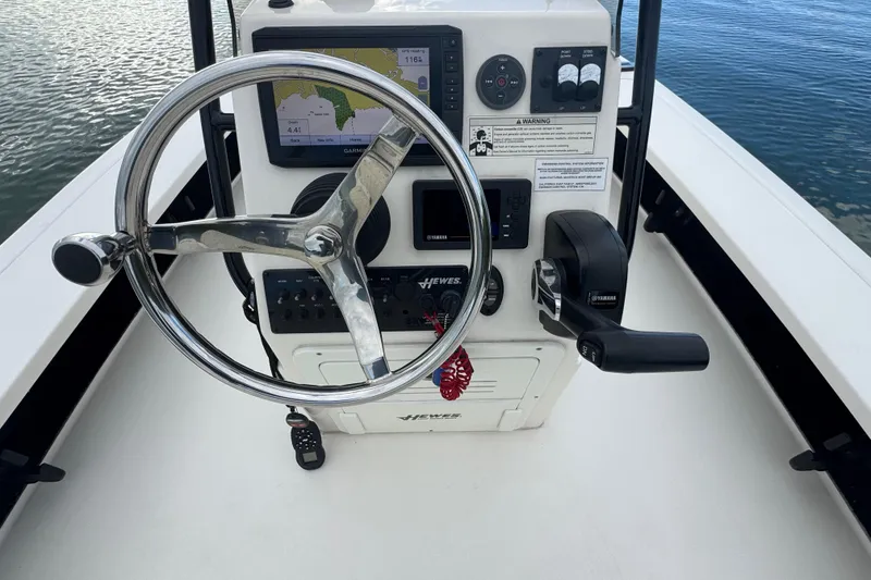 Slide: The Image of 2018 Hewes Redfisher 18 boat console with steering wheel and navigation system. - 3