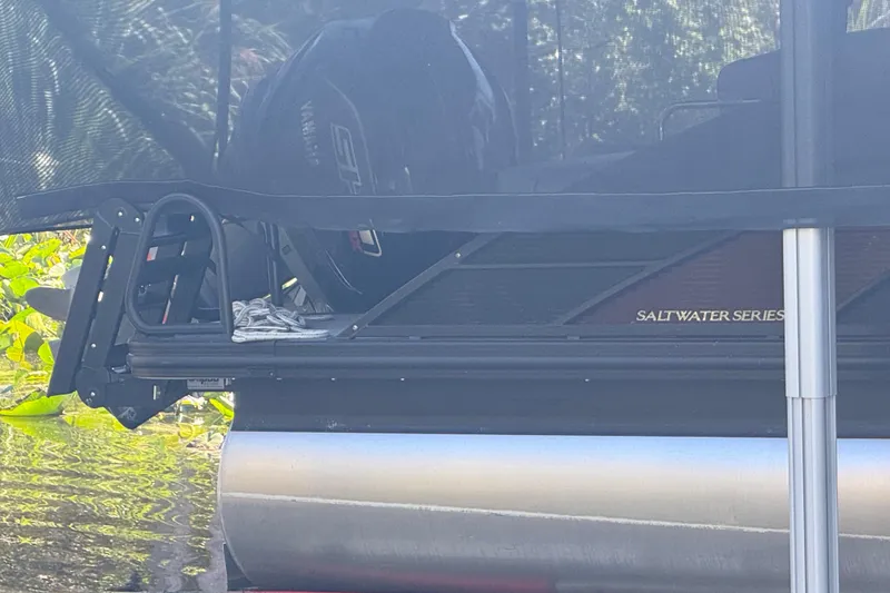 Slide: The Image of 2024 Bennington L Line Saltwater Series pontoon boat, partially visible in water. - 11