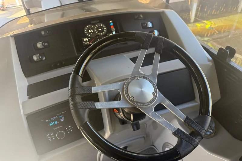 Slide: The Image of 2024 Bennington L Line boat dashboard with steering wheel and control panel. - 21