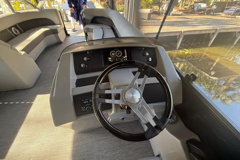 Slide: The Image of 2024 Bennington L Line boat interior with steering wheel and seating area. - 22