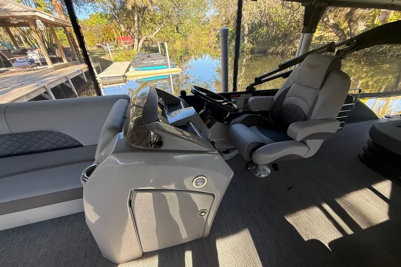 Slide: The Image of 2024 Bennington L Line boat interior with luxurious seating and modern helm. - 23