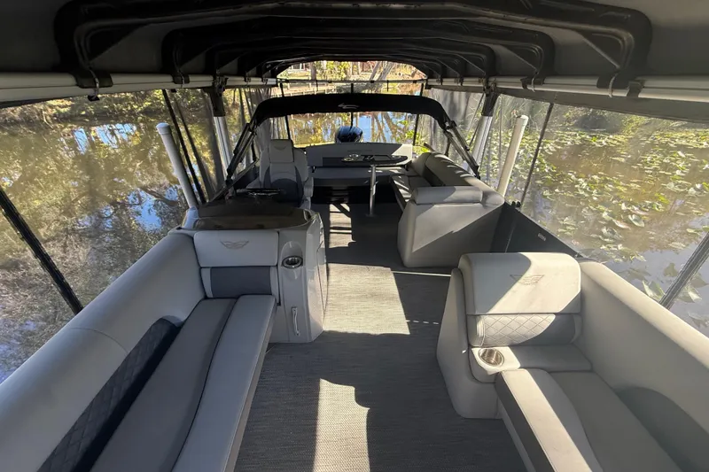 Slide: The Image of 2024 Bennington L Line pontoon boat interior with luxurious seating and canopy. - 24