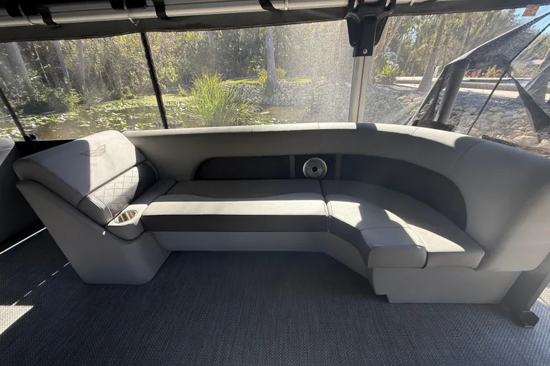 Slide: The Image of 2024 Bennington L Line boat interior with luxurious gray seating and cup holder. - 25