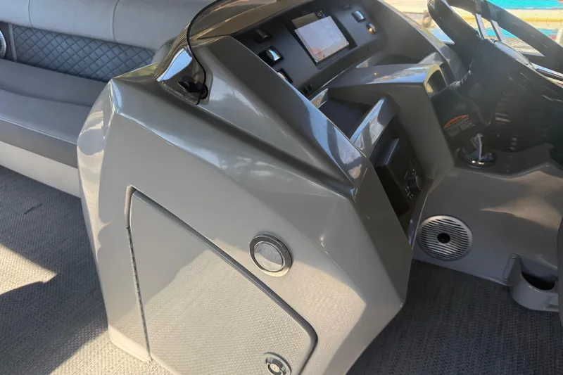 Slide: The Image of 2024 Bennington L Line boat dashboard with modern controls and seating. - 28