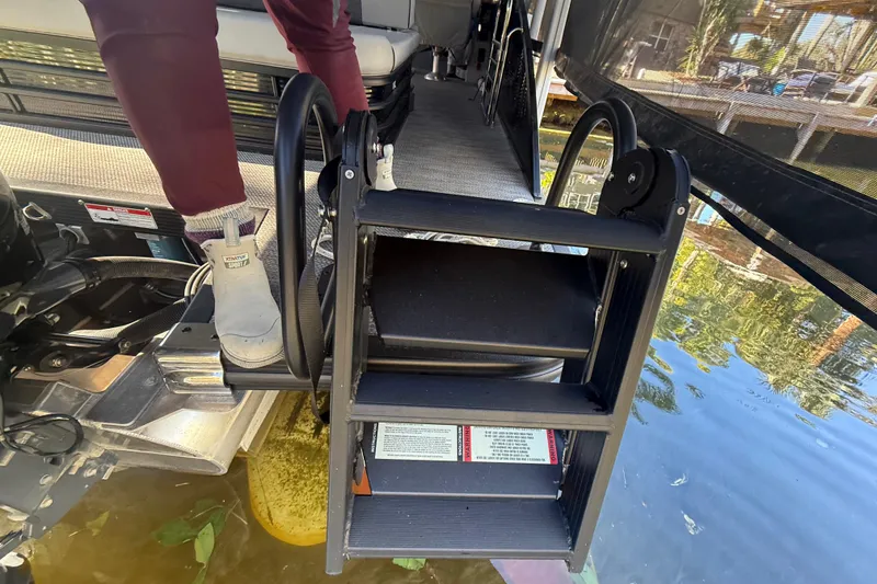 Slide: The Image of 2024 Bennington L Line boat ladder with person stepping onto dock. - 31