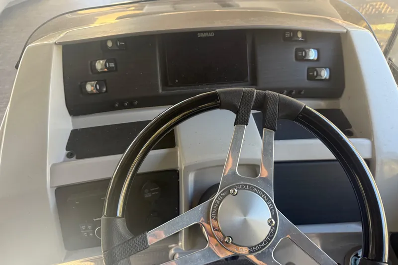 Slide: The Image of 2024 Bennington L Line boat dashboard with steering wheel and control panel. - 36