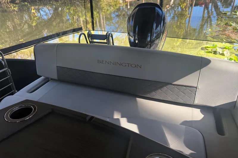 Slide: The Image of 2024 Bennington L Line boat interior with luxurious seating and cup holders. - 37