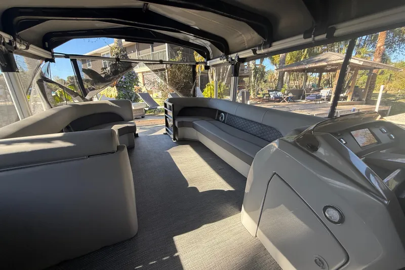 Slide: The Image of 2024 Bennington L Line pontoon boat interior with luxurious seating and modern design. - 38