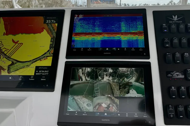 Slide: The Image of Control panel of a 1985 Bertram 54 Convertible with Garmin navigation displays. - 12
