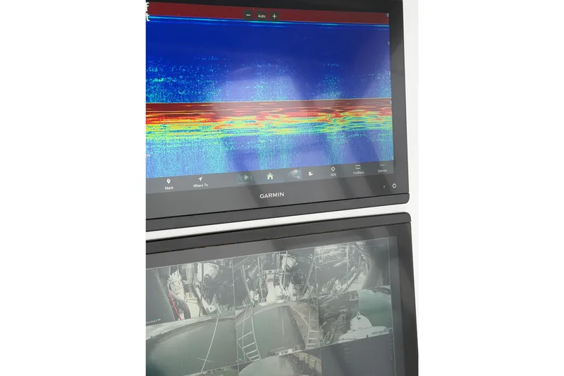 Slide: The Image of Garmin marine display on 1985 Bertram 54 Convertible, showing sonar and camera feeds. - 14